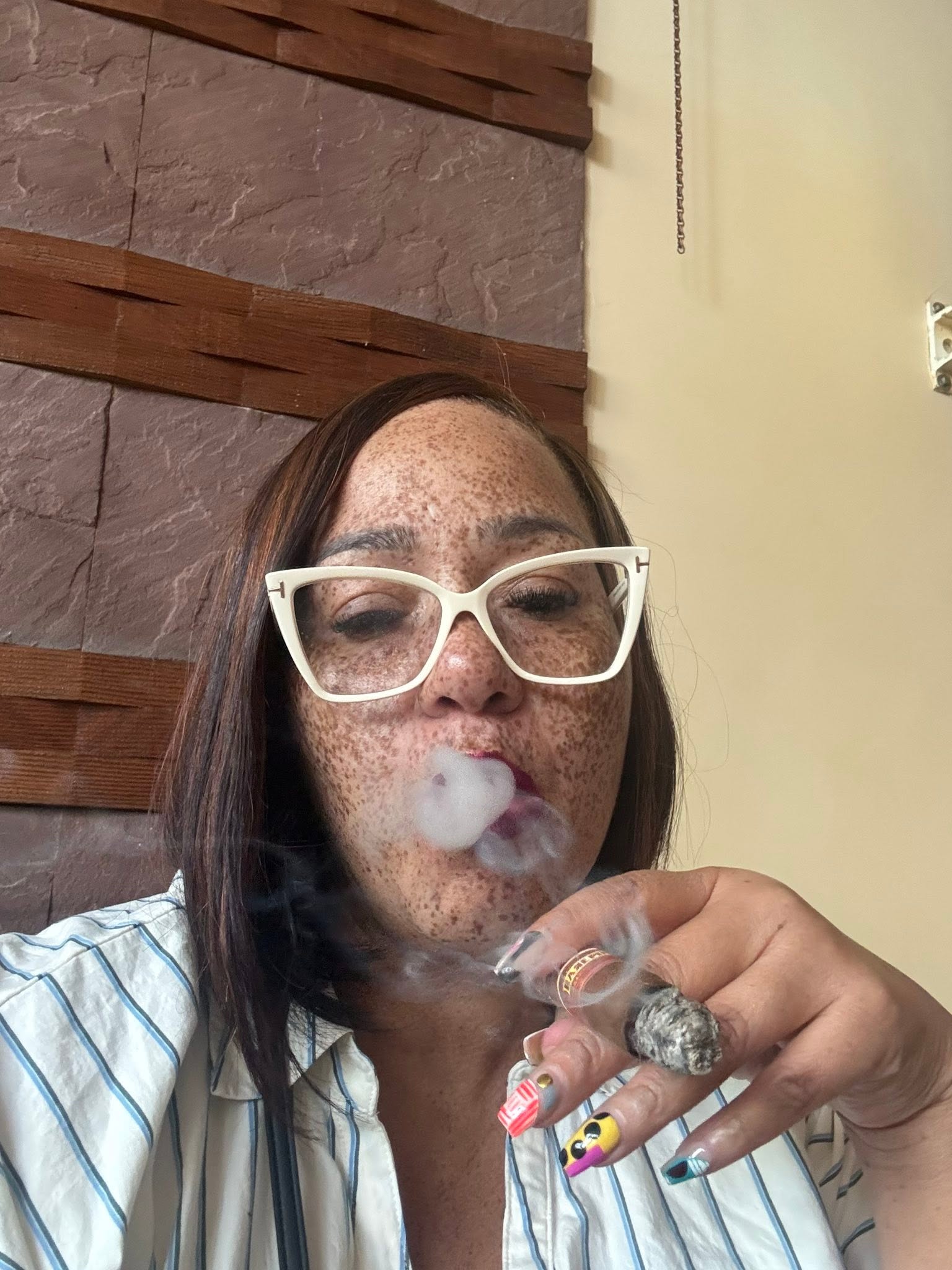A Her Stixx community member enjoying a cigar